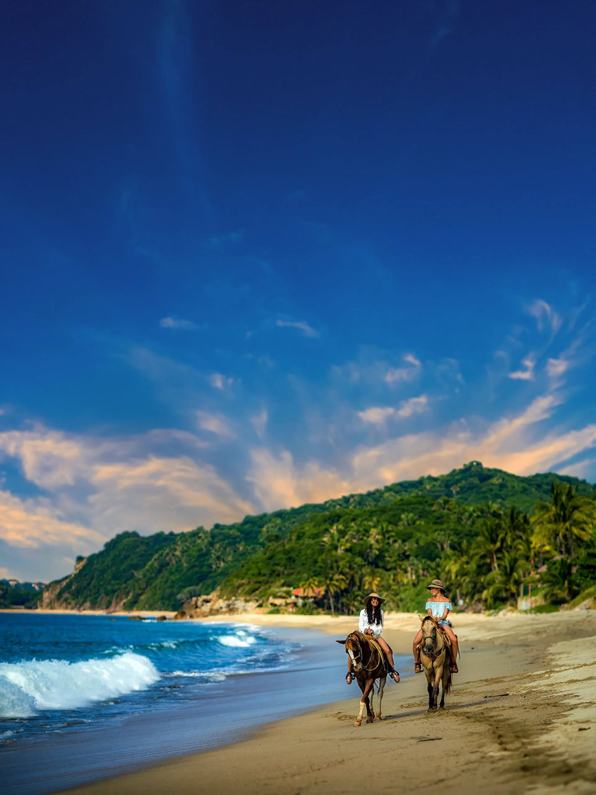 Horseback riding along the shoreline of the exclusive Litibu beach, surrounded by tropical jungle in Riviera Nayarit.